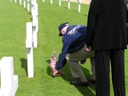 Gene Goodrick placing sprig and poppy at another 384th grave.JPG