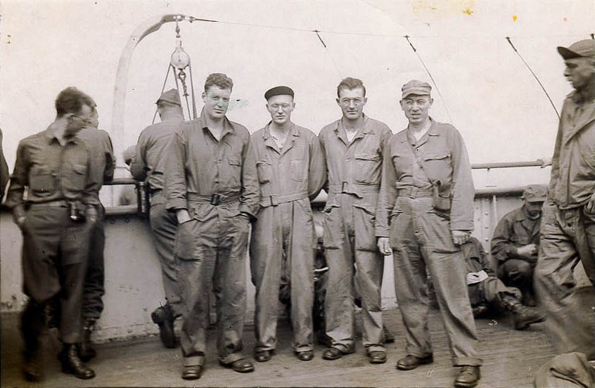 Charles Renshaw on the right of the group of 4, aboard ship either to or from England. Can ayone ID the others