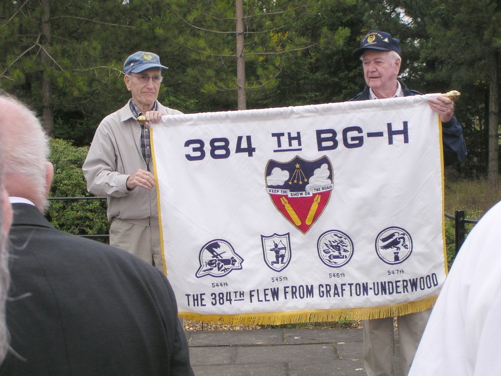 Dave Lustig and Gene Goodrick hold the 384th banner at the monument.JPG