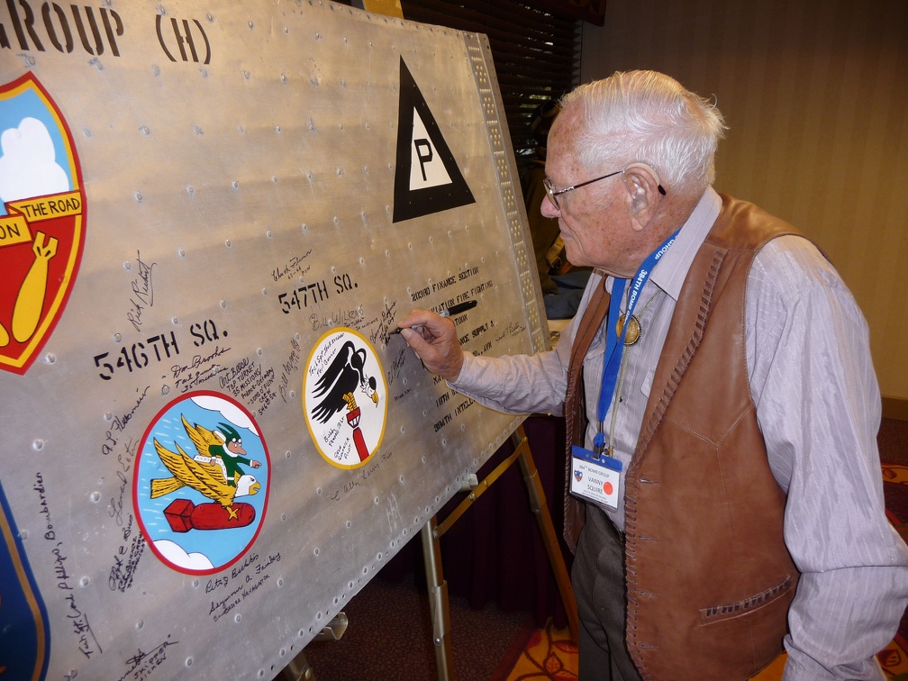 Vanny Squier signing the wing panel.