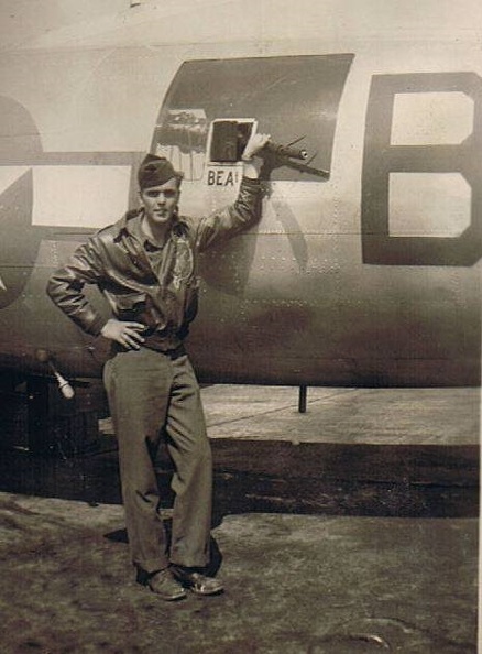 Russell Don Reams beside B-17 and his side gunner post.jpg