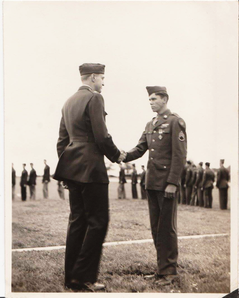 John S. Fox Jr. presented the Distinguished Flying Cross by Colonel Dale O. Smith.  24 July 1944..png