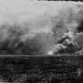 Smoke-filled horizon and fire at unimproved airfield