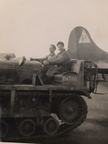 Cletrac, unnamed men, unidentified aircraft