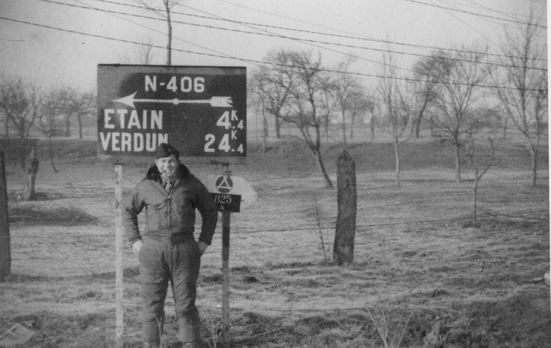 Man with pipe in front of sign.jpg