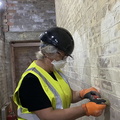 Helen hard at a thankless task.. Clearing lime wash paint off.